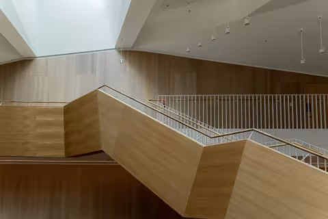 Custom open riser staircase installation completed by AC Brothers in Mississauga — solid oak treads with iron spindles