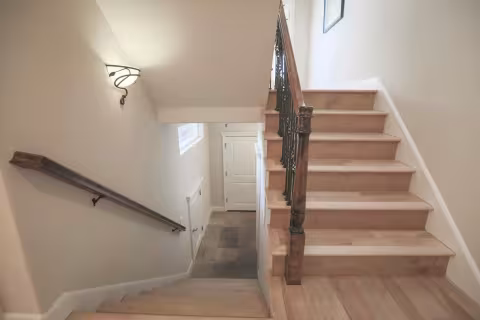 L-shaped staircase with hardwood landing installed across the GTA — custom build by AC Brothers